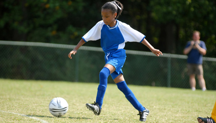 teen girl playing soccer