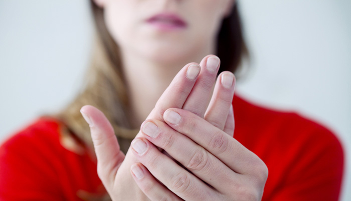lady holding hand with painful fingers