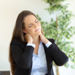 woman at work desk cracking her neck