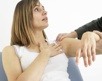doctor examining patients shoulder