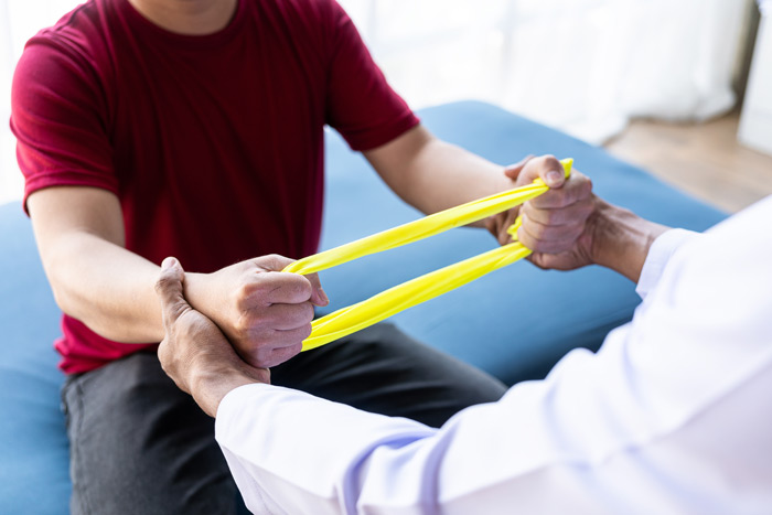 man exercising with elastic bands